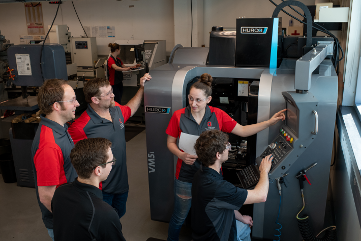 Group of students beside a 3-D printer