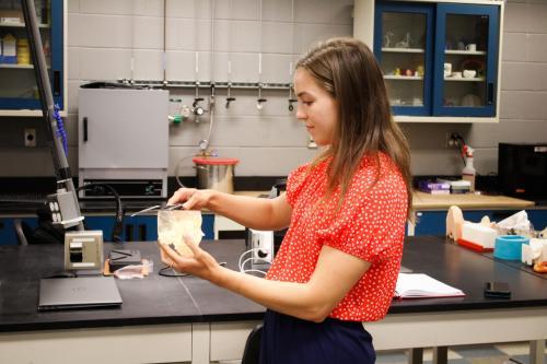 Picture of a female student in a lab