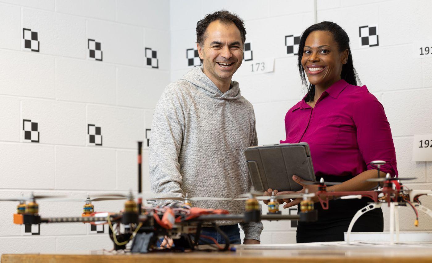 Picture of a man and a woman with drones on a table.