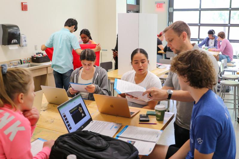 Group of students and faculty in a classroom.