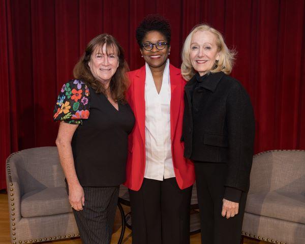 Three professional women at a symposium