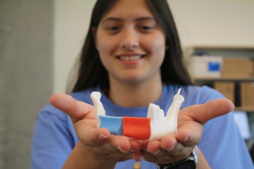 Student holding a 3-D printed model