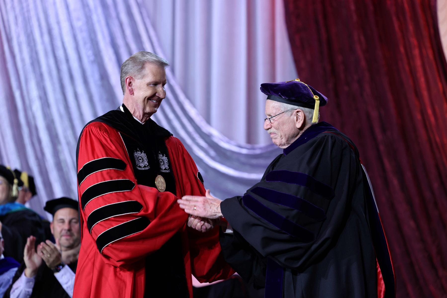 President Carter and Board of Trustees Chairman John Zeiger shake hands at the investiture ceremony