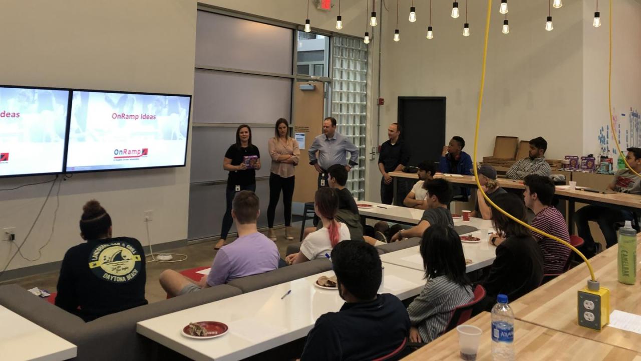 A group to students listening to a presentation about OnRamp.